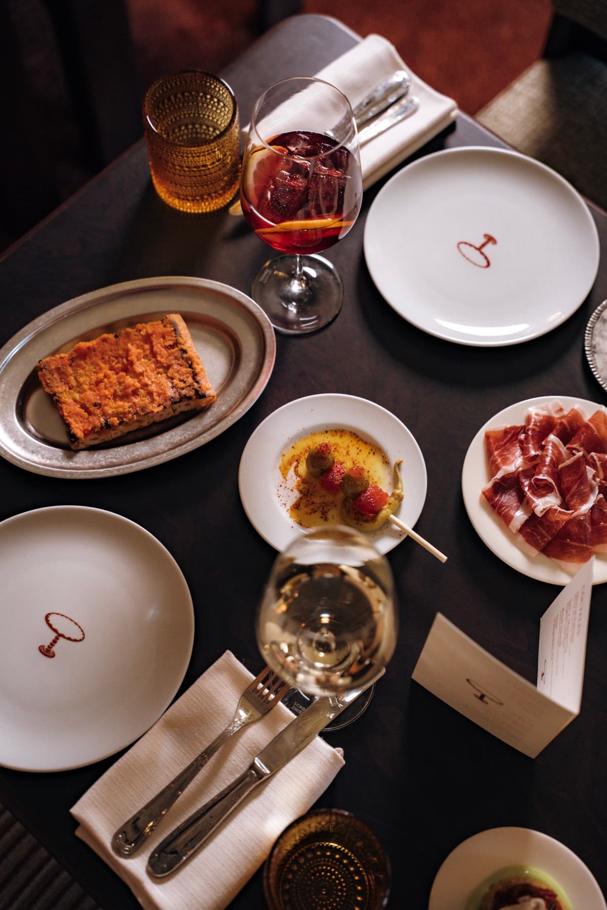 A table spread with tapas, wine and Mesa Mesa plates